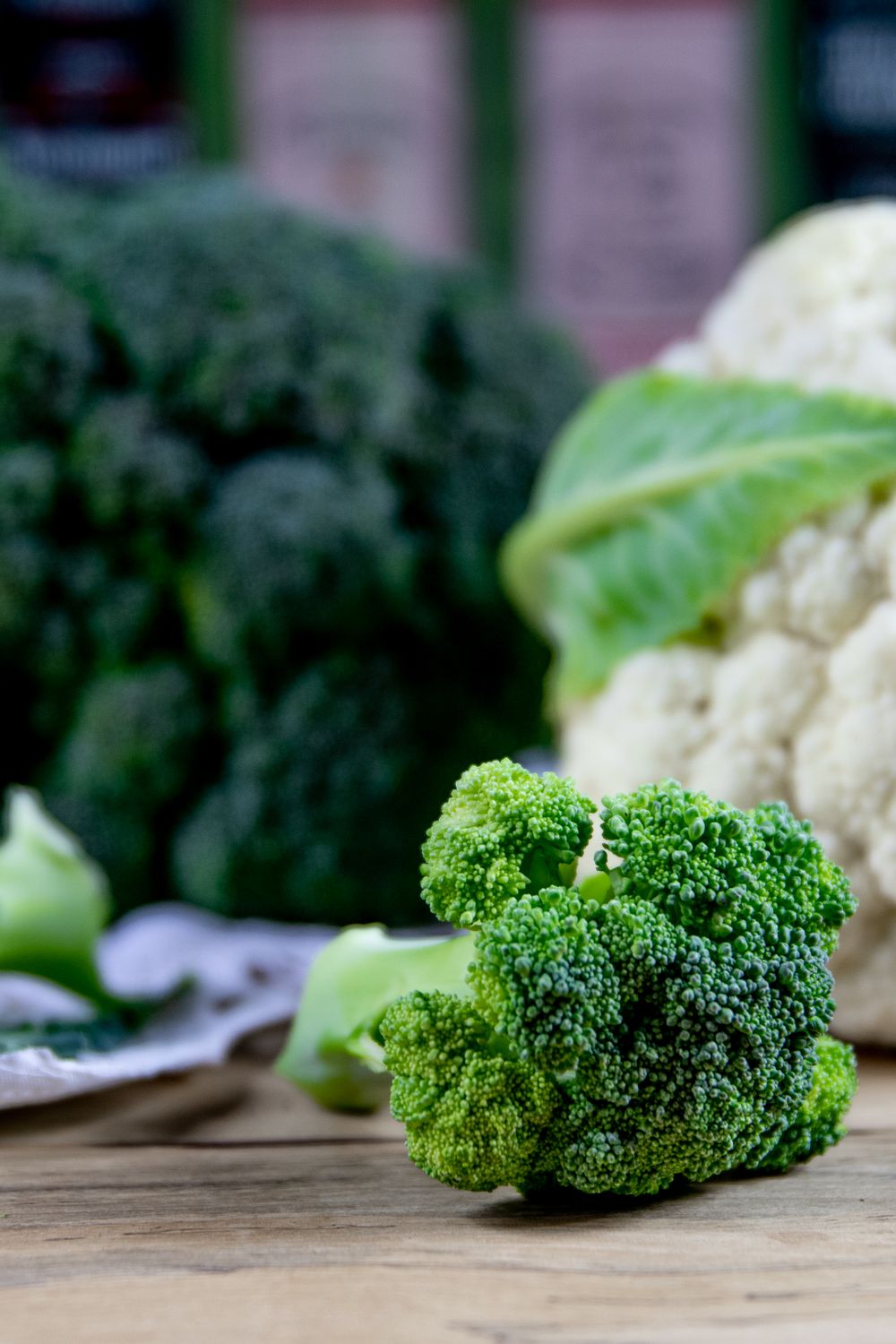 Fresh broccoli and cauliflower florets on a wooden table