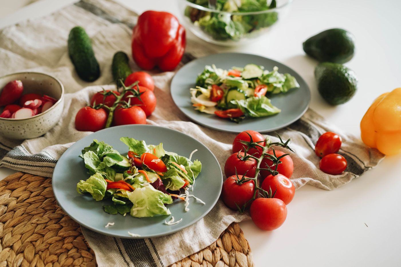 A colorful salad plate with cherry tomatoes and avocado